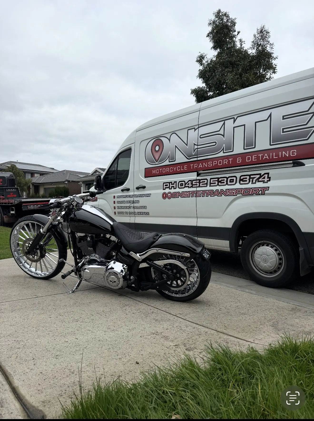 Onsite branded transport van with a black custom motorcycle outside