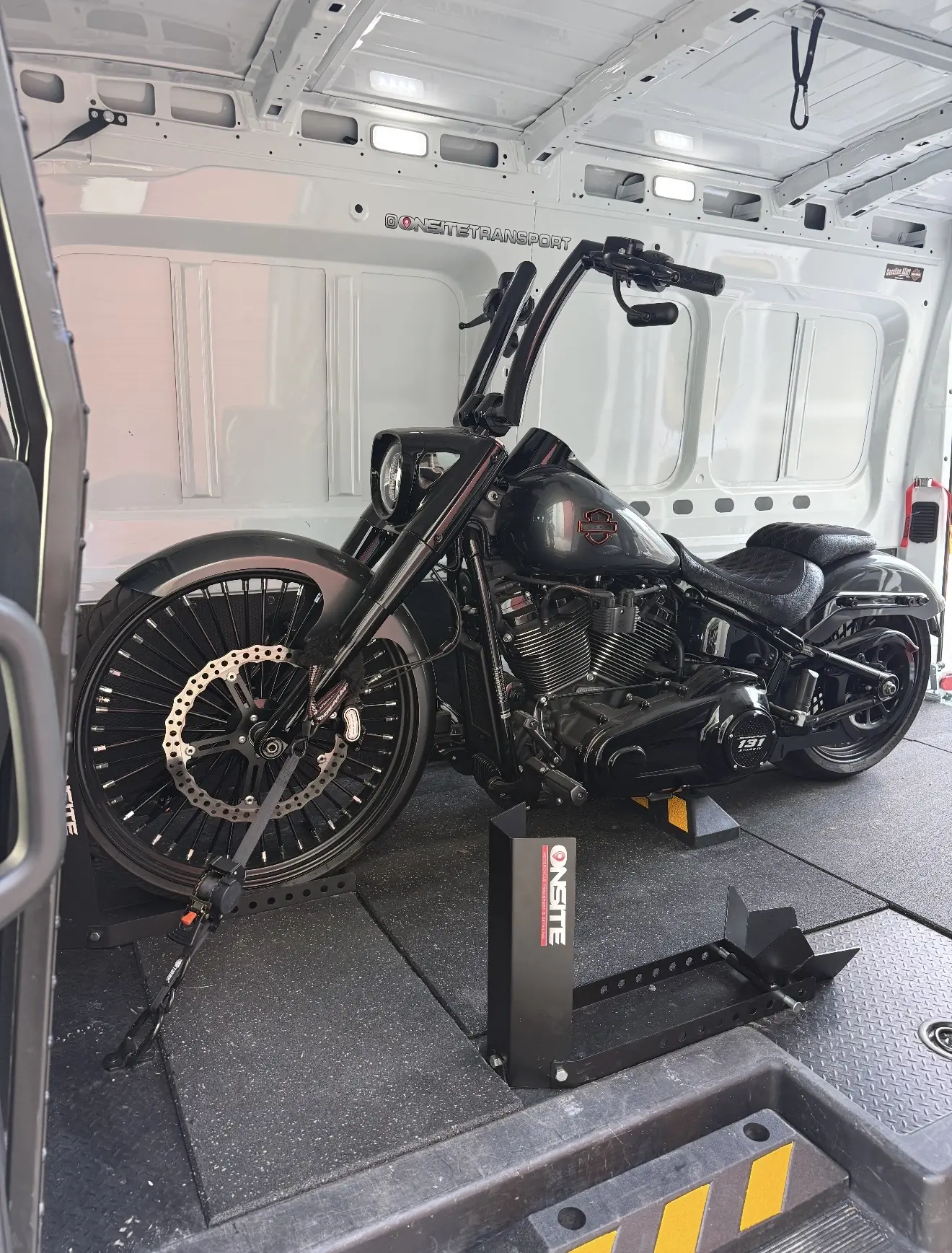 Black custom motorcycle secured inside the Onsite enclosed transport van