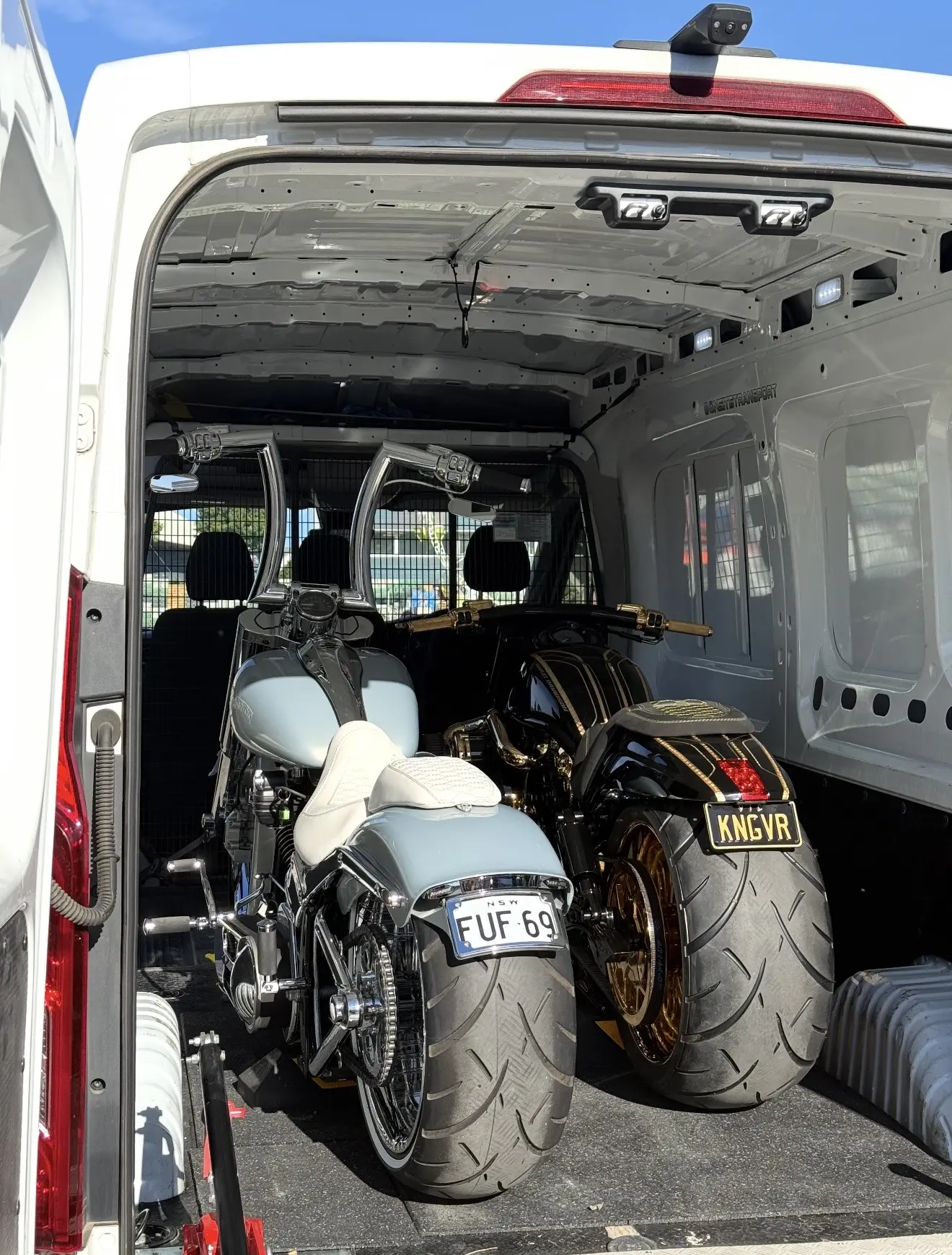 Two custom motorcycles secured inside the Onsite enclosed transport van