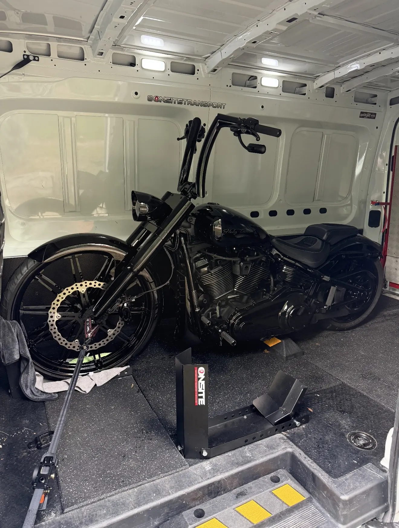 Black custom motorcycle secured in the Onsite motorcycle transport system