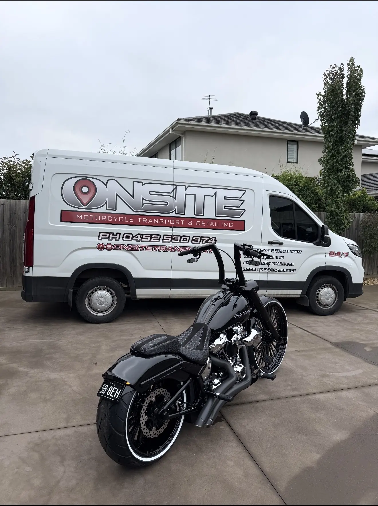 Onsite transport van and a black motorcycle ready for collection