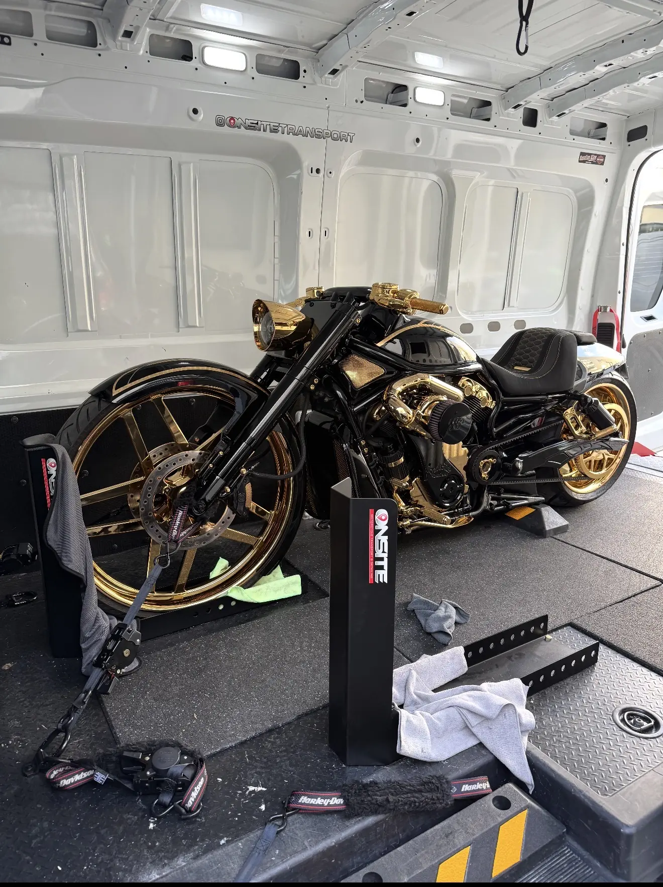 Black and gold custom motorcycles secured for enclosed transport
