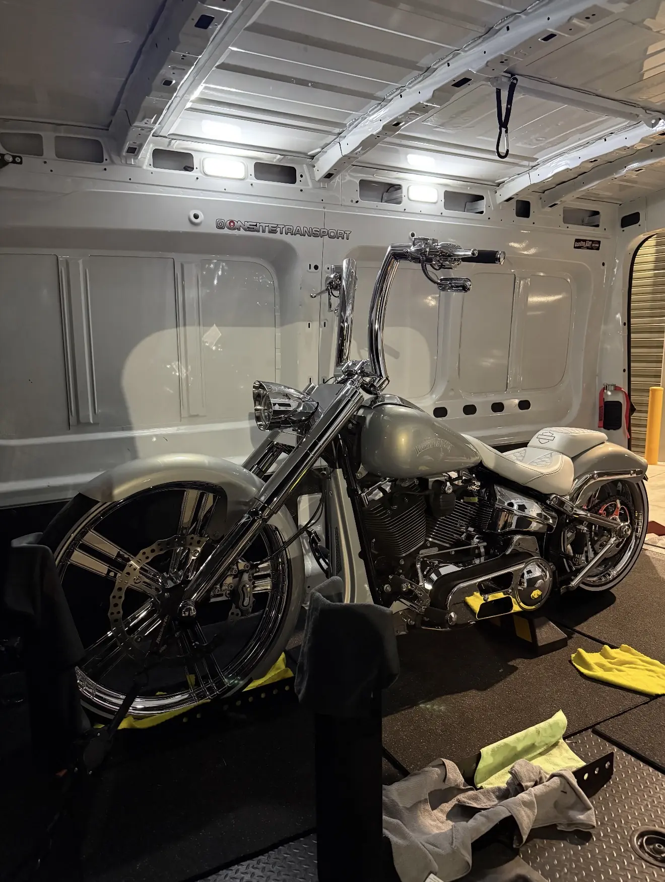 Grey custom motorcycle secured inside the Onsite transport van