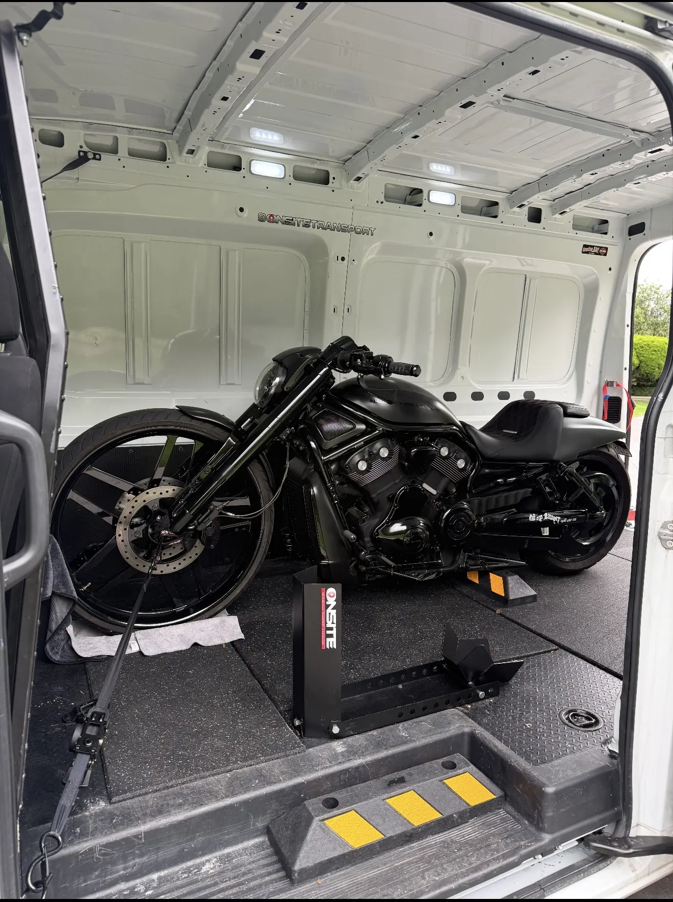 Black cruiser motorcycle secured inside the Onsite transport van