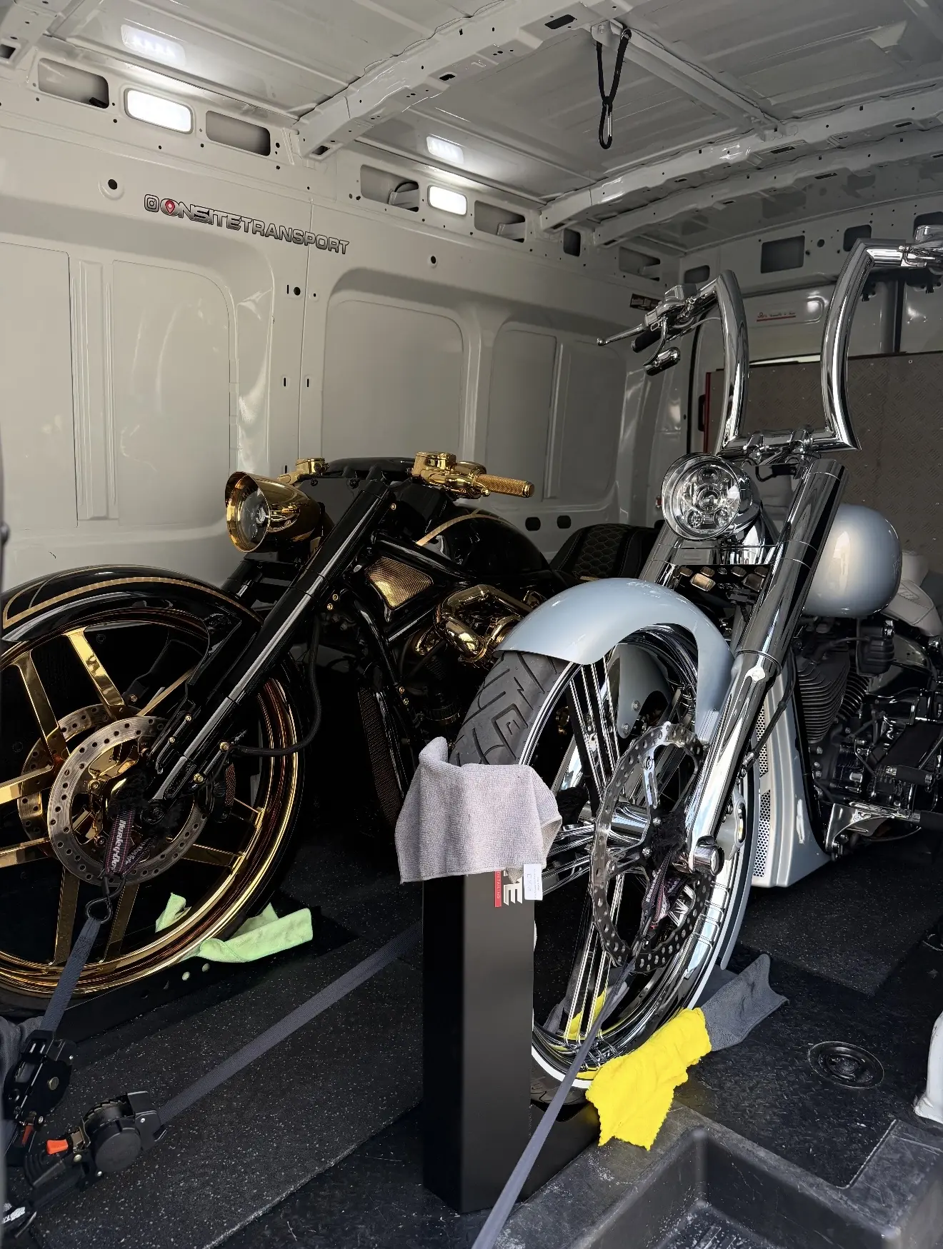 Pair of custom motorcycles secured inside the transport van