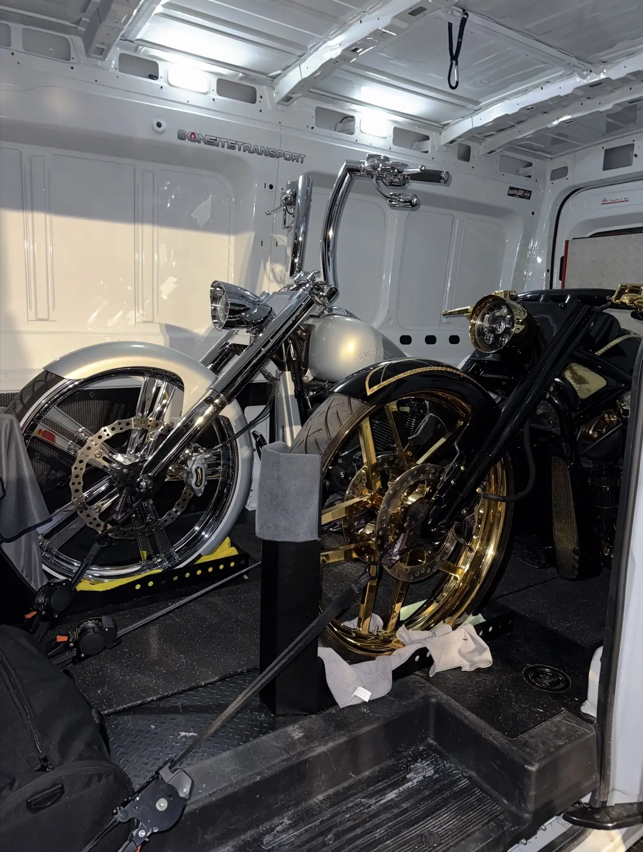 Black and gold motorcycles secured for careful enclosed transport