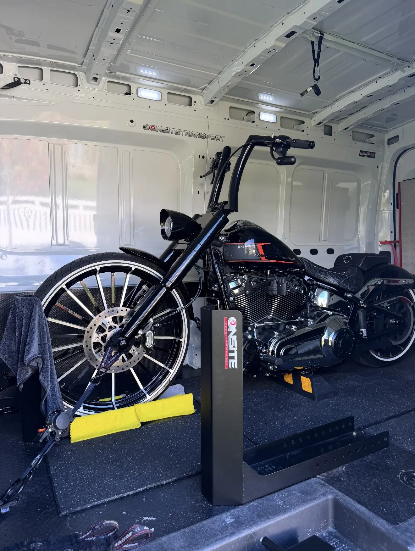 Black custom motorcycle positioned in the Onsite transport system