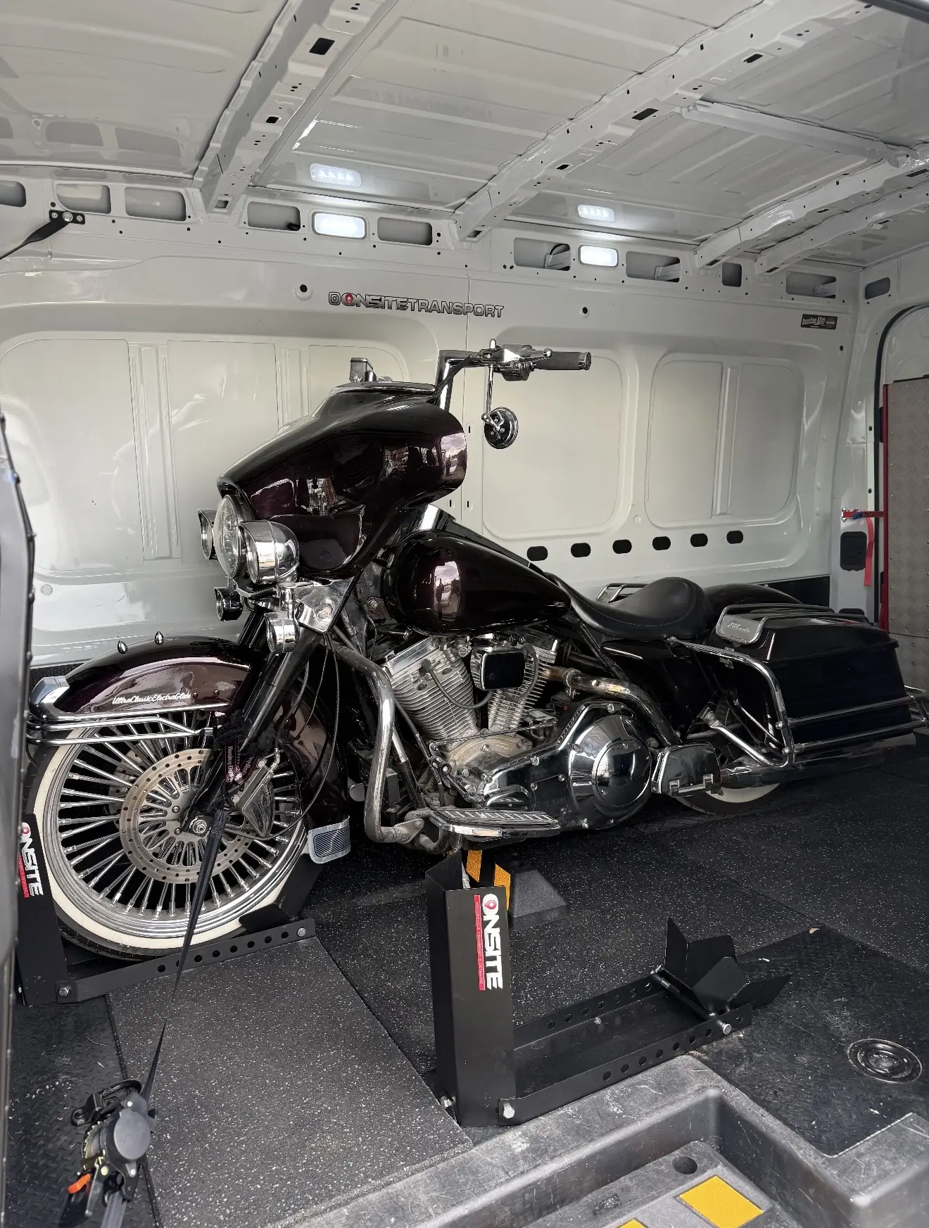 Classic touring motorcycle secured inside the enclosed van