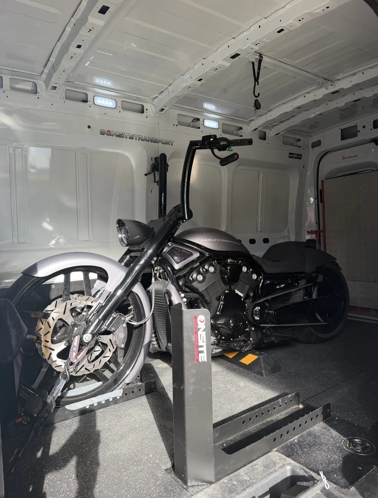 Black custom cruiser secured inside the Onsite transport van