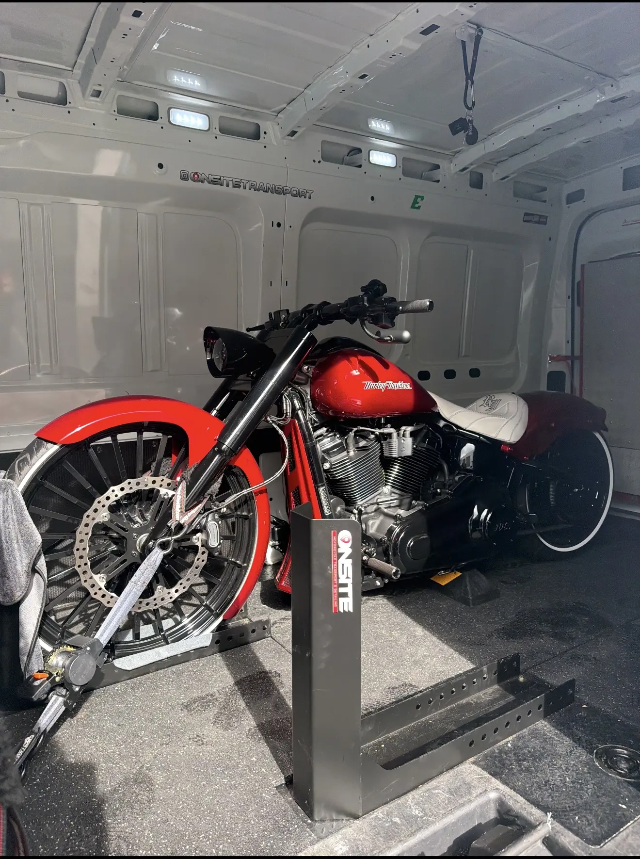 Red custom motorcycle prepared for enclosed transport