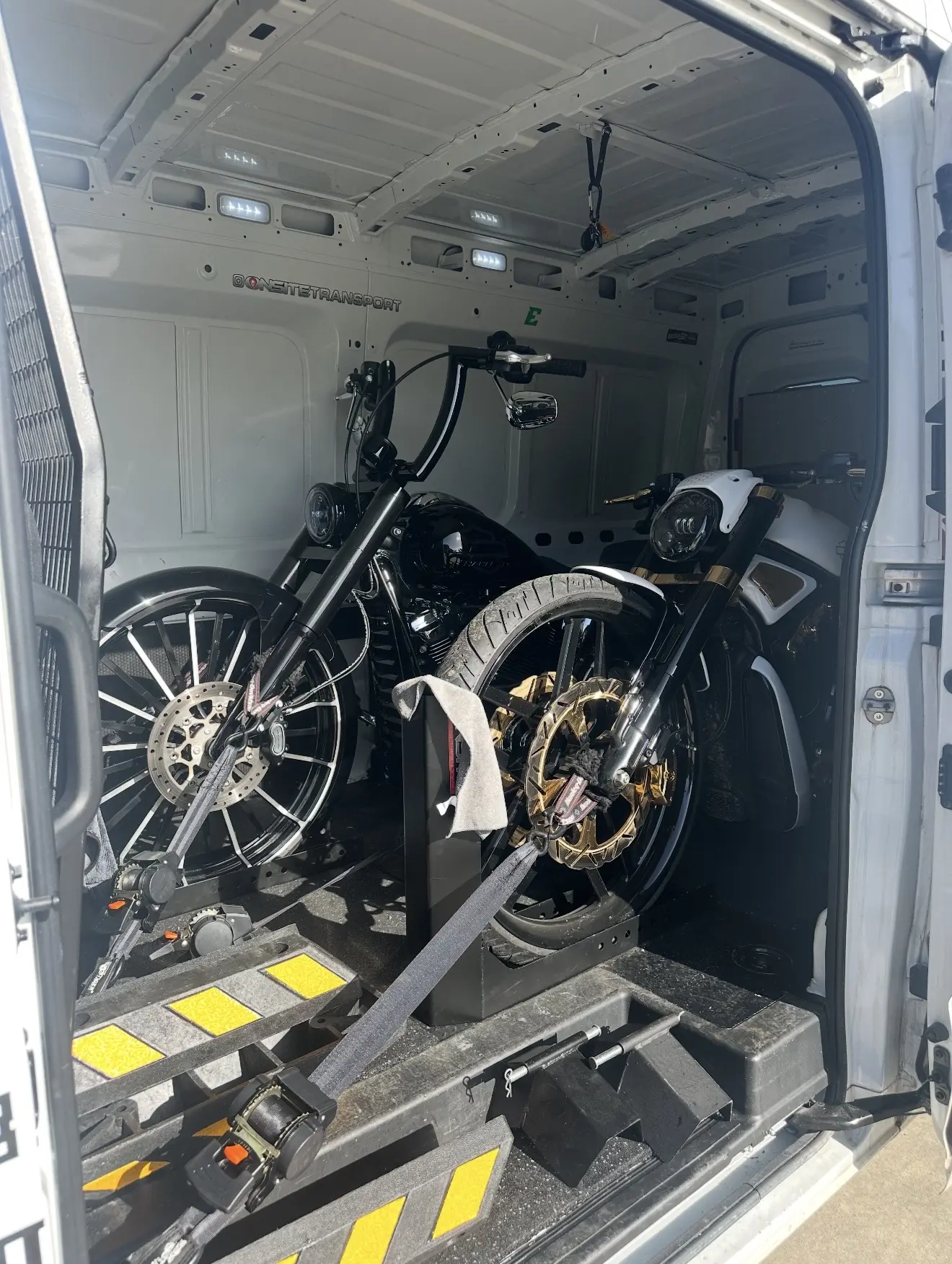 Two custom motorcycles secured inside the Onsite enclosed van